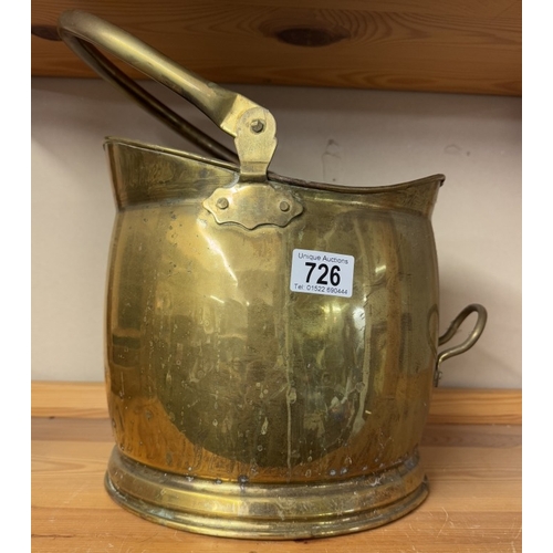 726 - An old brass coal scuttle.