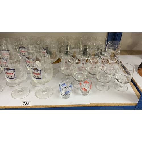 739 - A large lot of pub glasses including some branded