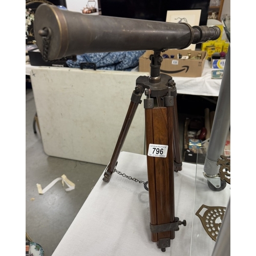 796 - A brass telescope with patina to surface on teak tripod