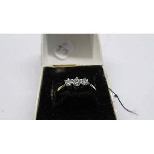 1001 - An 18ct gold three stone diamond ring, size M, 2.16 grams.