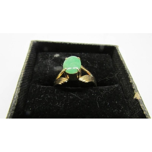 1007 - An 18ct gold jade ring, size P,  302 grams