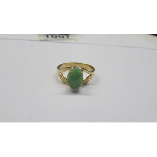 1007 - An 18ct gold jade ring, size P,  302 grams