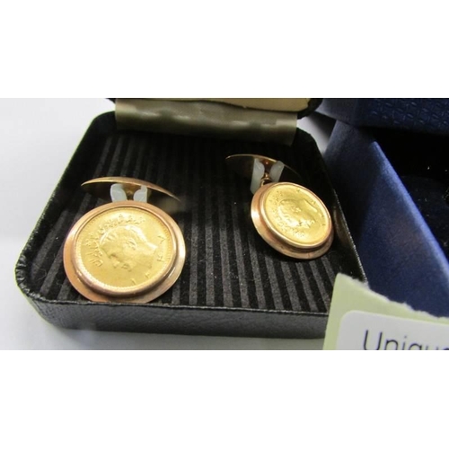 1017 - A pair of Swarovski crystal cuff links and a pair of Shah of Persia coin cuff links.