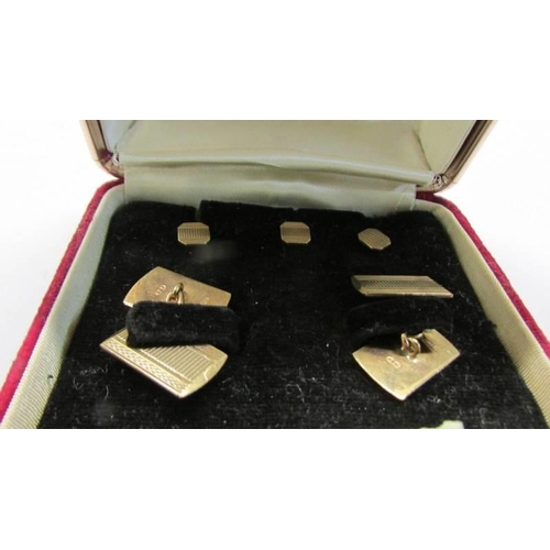 1020 - A pair of gold cuff links with three matching studs in original box.