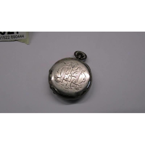 1027 - A small monogrammed silver pocket watch.