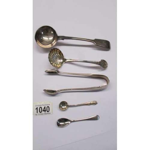 1040 - A sauce ladle, a sifter spoon, sugar tongs and two salt spoons.