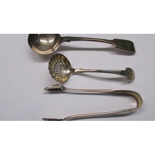 1040 - A sauce ladle, a sifter spoon, sugar tongs and two salt spoons.