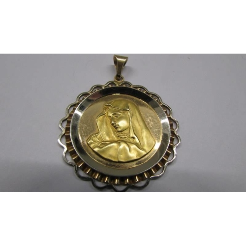 1042 - An 18ct gold religious pendant featuring Mary, 7.83 grams.