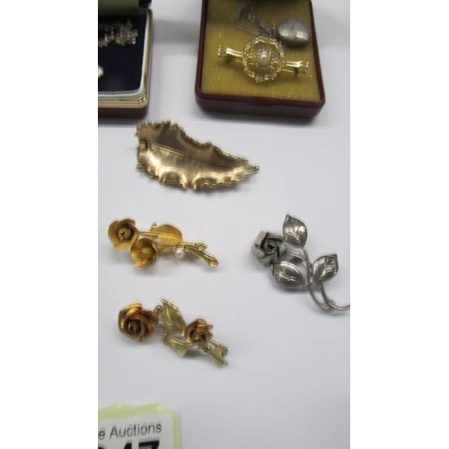 1047 - A mixed lot including enamel cross, bar brooch, locket, orchid brooch with matching earrings and oth... 