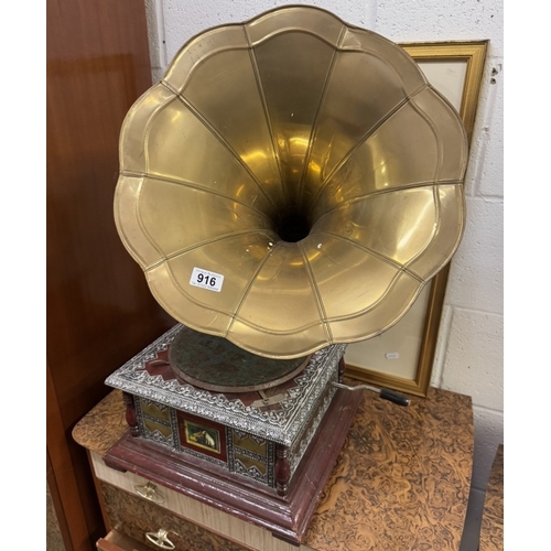 916 - An ornate horn gramophone with brass horn.