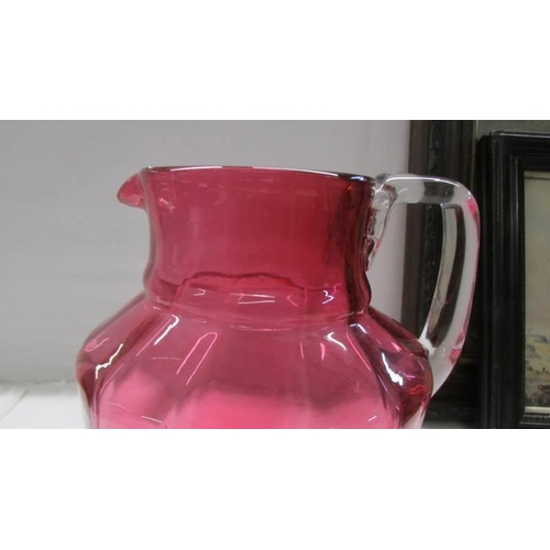 1053 - A nice cranberry glass jug, no cracks or chips, 20 cm tall.