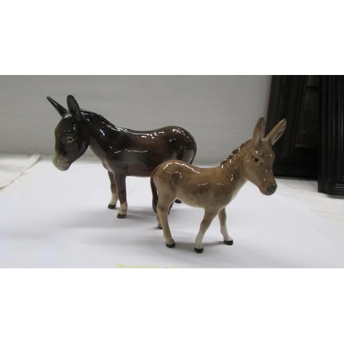 1066 - Two Beswick donkeys.