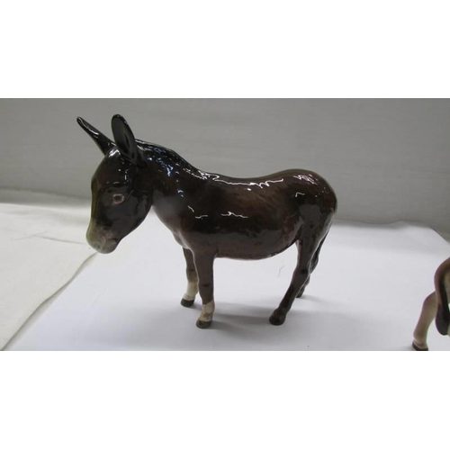 1066 - Two Beswick donkeys.