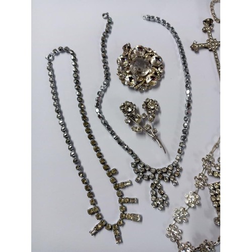 502 - Eight pieces of diamonte' jewellery including cross pendant.