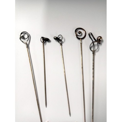 510 - Three long and two shorter Samson Morden hat pins.