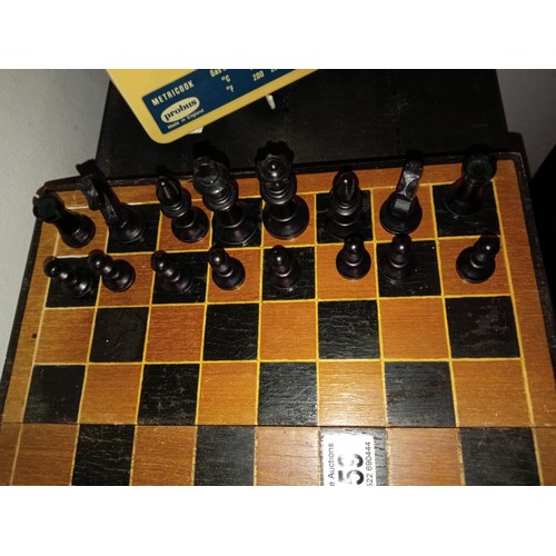 559 - A vintage wooden chess set with folding board box