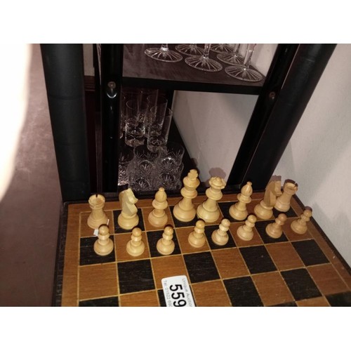 559 - A vintage wooden chess set with folding board box