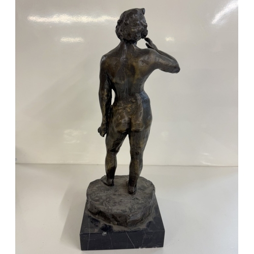 1382 - A bronze figure of a female nude.