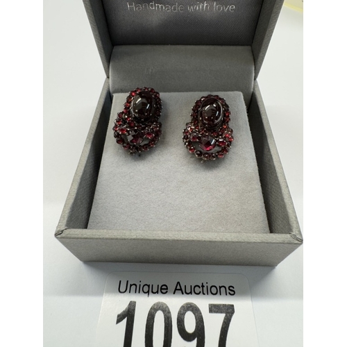 1097 - A pair of 19th century garnet stud earrings, cabochon cut garnets, centre stone, yellow metal set.