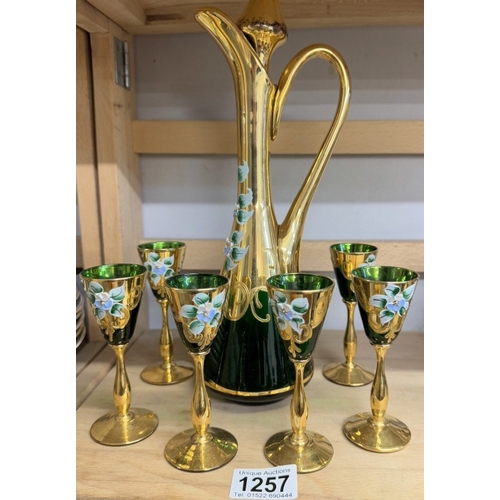 1257 - A green glass & gilt decanter with 6 glasses