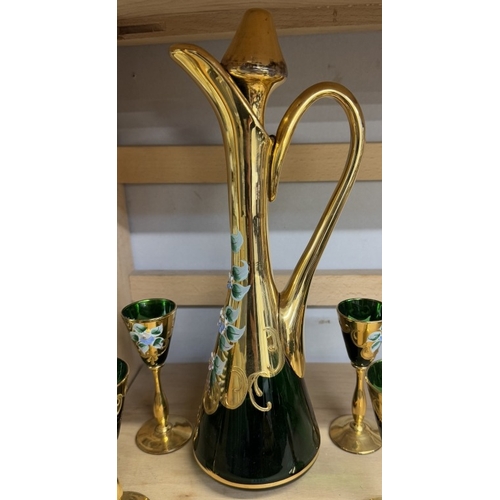 1257 - A green glass & gilt decanter with 6 glasses