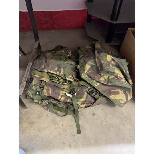 1291 - A quantity of camouflage back packs etc. including webbing & pouches etc.