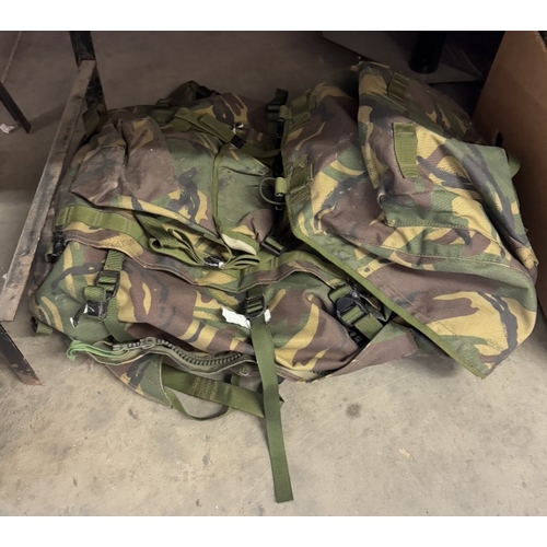 1291 - A quantity of camouflage back packs etc. including webbing & pouches etc.