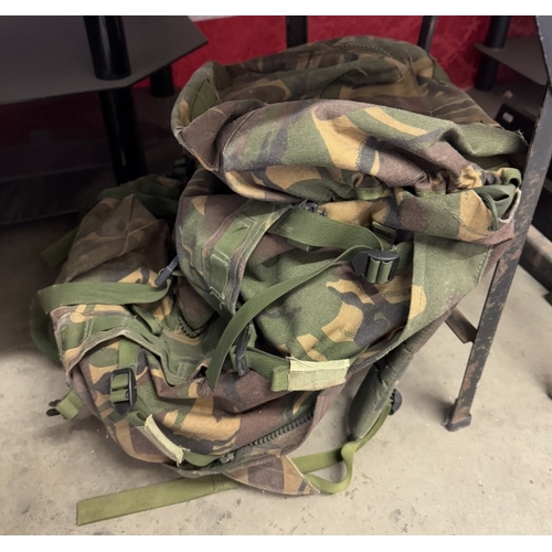 1291 - A quantity of camouflage back packs etc. including webbing & pouches etc.