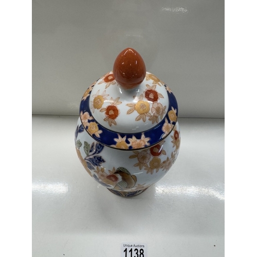 1138 - A Chinese pottery trio of 2 urns & centre vase