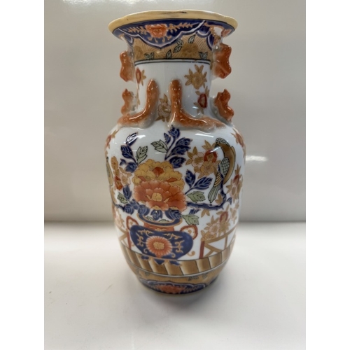 1138 - A Chinese pottery trio of 2 urns & centre vase