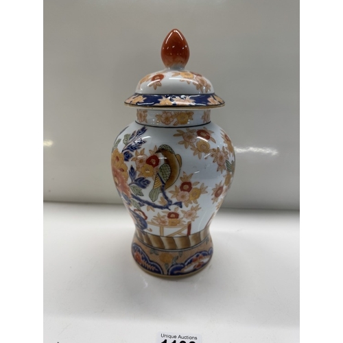 1138 - A Chinese pottery trio of 2 urns & centre vase