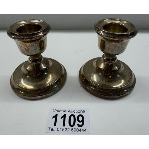 1109 - A pair of short sterling silver filled candlesticks. Height 6.5cm