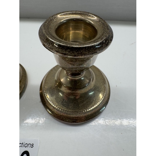 1109 - A pair of short sterling silver filled candlesticks. Height 6.5cm