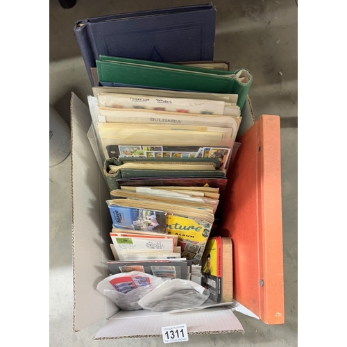 1311 - A collection of stamps including 8 albums, stock cards, loose stamps, many on paper, covers, large q... 