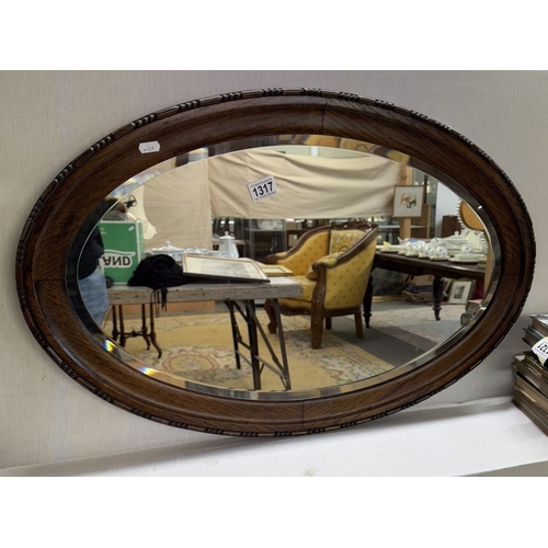 1317 - A wood framed oval mirror