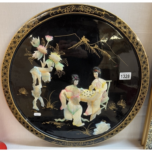 1328 - A circular oriental plaque featuring Chinese ladies in mother of pearl.