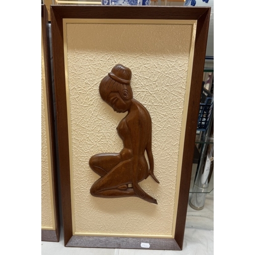 1332 - A pair of vintage circa 1970s framed teak wall carvings of a naked oriental on an anaglypta type bac... 