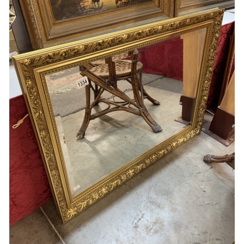 1334 - A gilt frame bevel edge mirror. 84 x 62cm