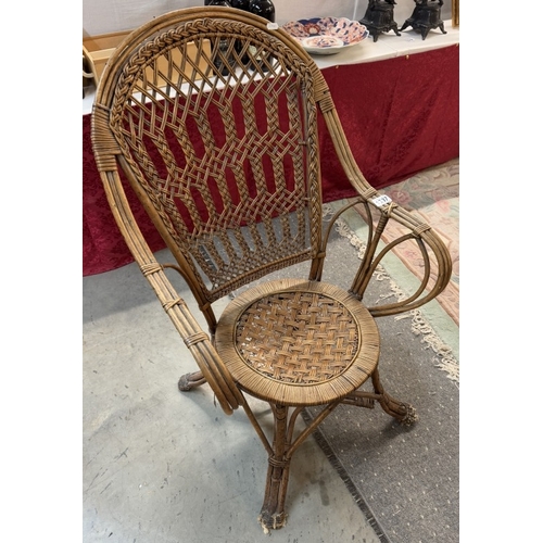 1337 - An ornate cane / rattan wing arm chair