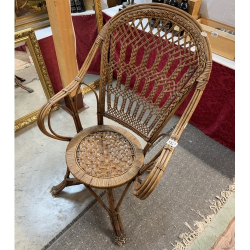 1337 - An ornate cane / rattan wing arm chair