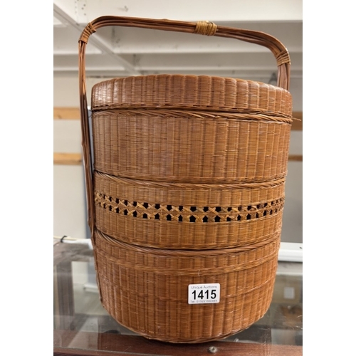 1415 - An oriental wicker multi layer basket