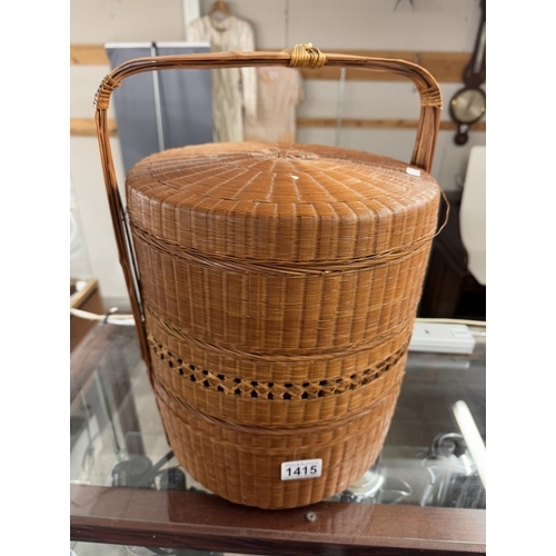 1415 - An oriental wicker multi layer basket