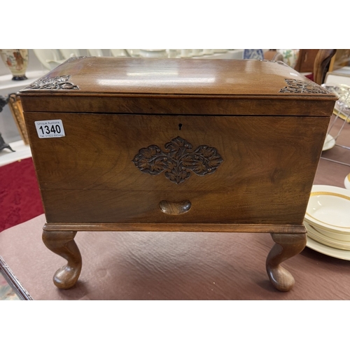 1340 - A hardwood box with carved decoration on Queen Anne legs