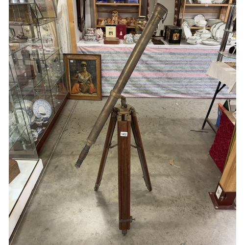 1432 - A patinated brass telescope on tripod base. Length 98cm.