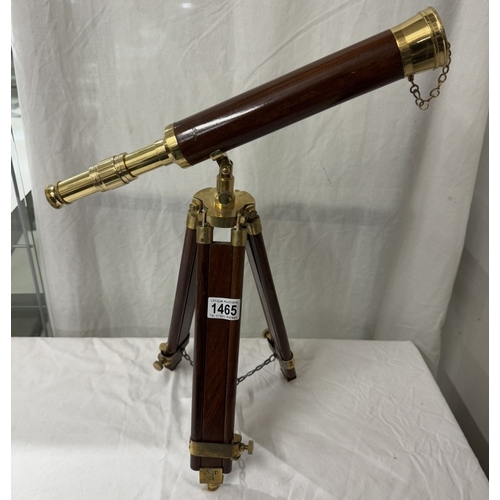 1465 - A brass telescope with wooden barrel on tripod base. Length 43cm