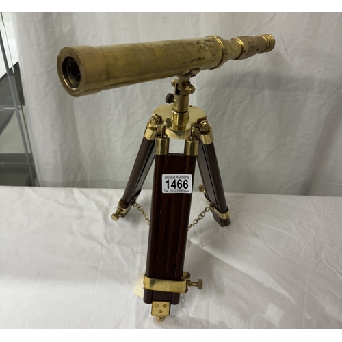 1466 - A brass telescope on tripod base. Length 37cm