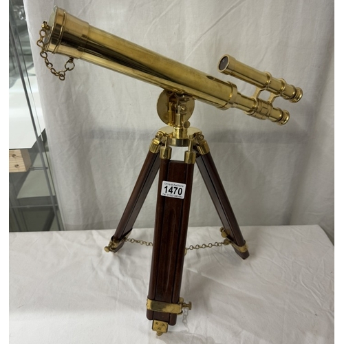 1470 - A polished brass telescope on tripod base. Length 43cm