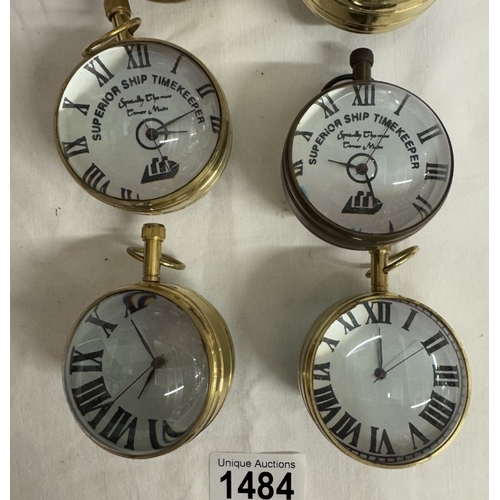 1484 - 6 Heavy brass & glass paperweight clocks with quartz movements.