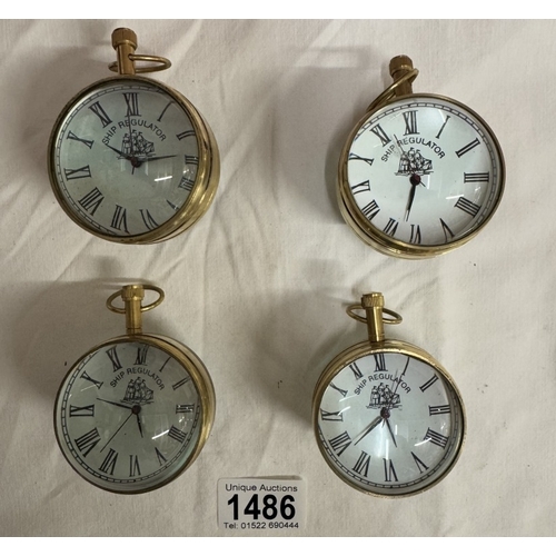 1486 - 4 Heavy brass & glass paperweight clocks with quartz movements.