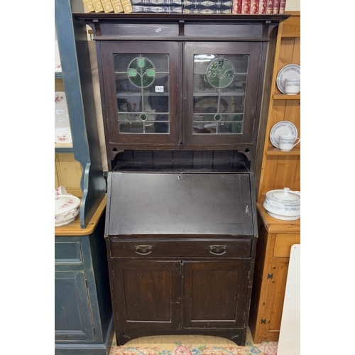 1423 - An Art nouveau oak bureau with leaded glass panels